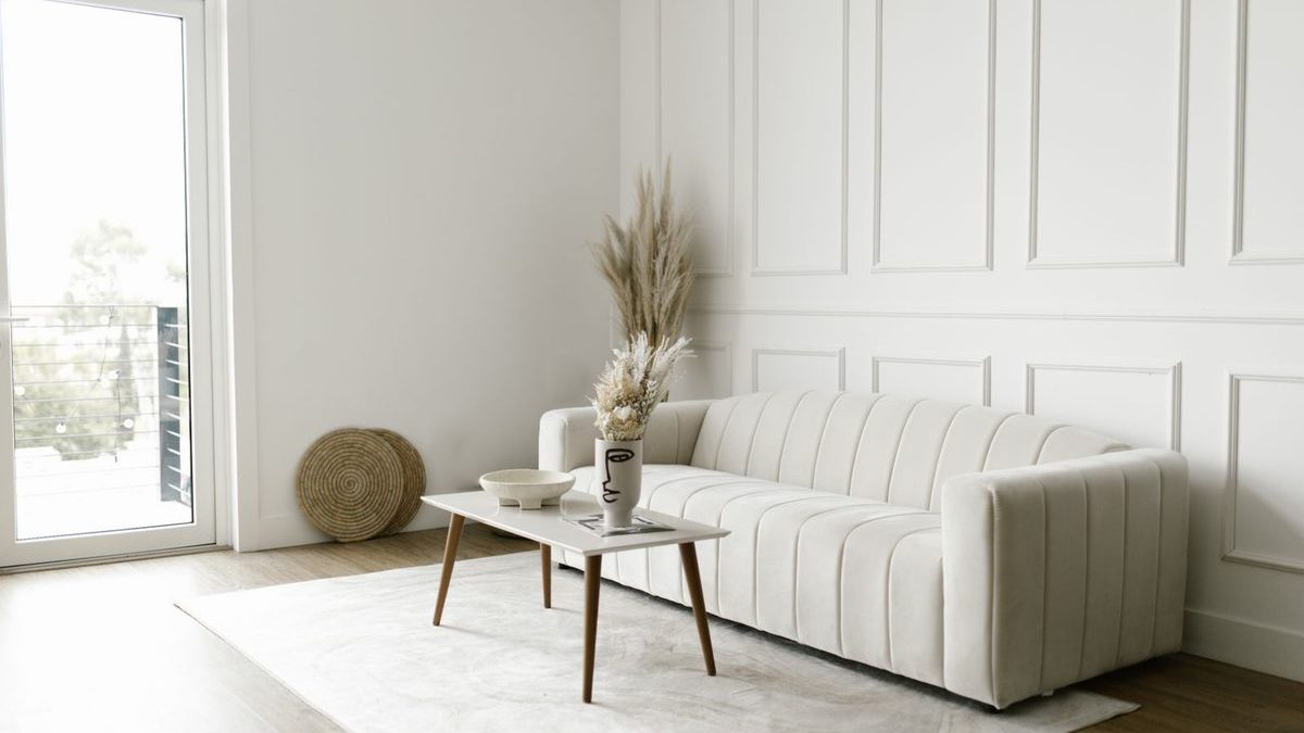 A pale sofa in a quiet, light-filled sitting room